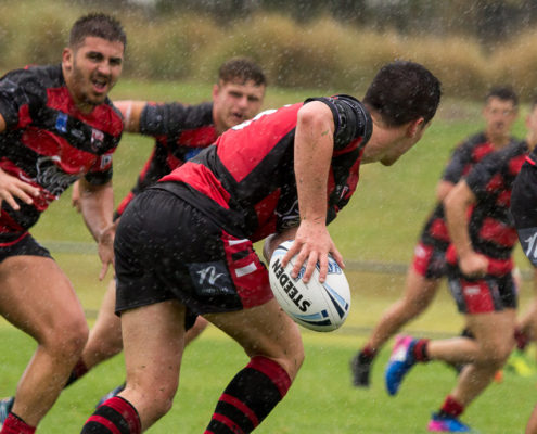 Jayden Griffin looks for the pass in the pouring rain with George Yarak & Matthew French in support - NSW Rugby League Junior Representative Competition - SG Ball Cup Competition [U18] Round 3 - Central Coast Roosters Vs North Sydney - Morie Breen Reserve - 25/02/2017 Photos by - Steve Little - www.redandblackzone.com